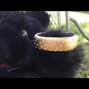 Hinged gold tone Swarovski crystal bracelet.